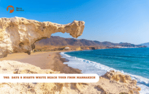 Merry Morocco tour card for 8 Nights White Beach Tour from Marrakech showing a natural rock arch over white sand and blue sea