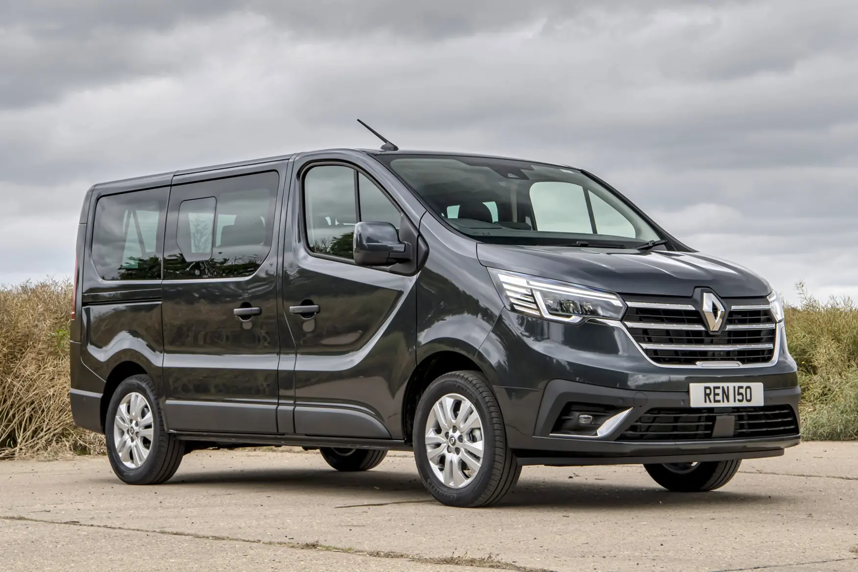Dark grey Renault Trafic minibus parked outdoors with UK number plate REN 150