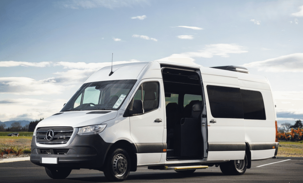 White Mercedes Sprinter minibus with sliding door open, parked for a private tour transfer