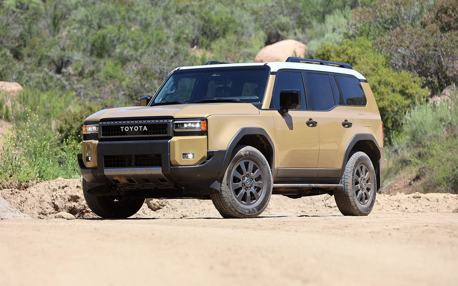 Toyota Land Cruiser on dirt road in arid Moroccan desert terrain